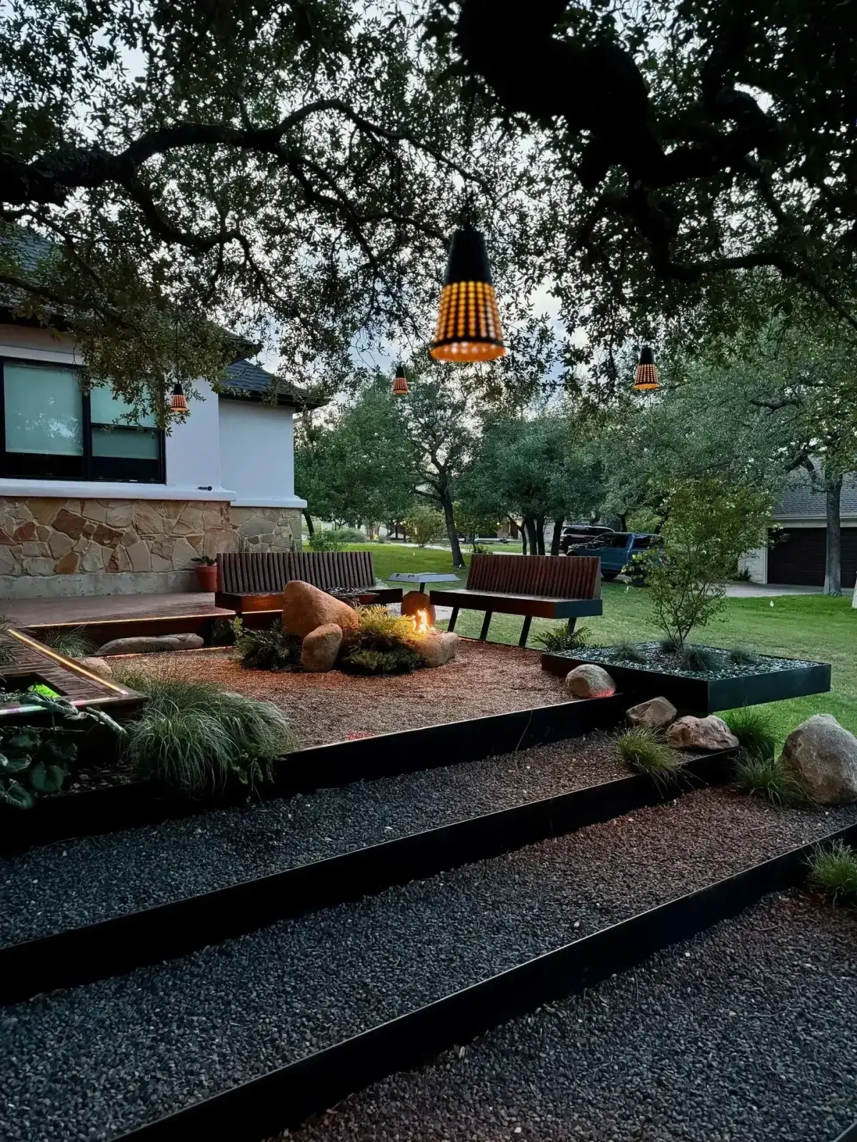 Outdoor living space with metal-roof cedar pergola and built-in kitchen — Red Agave Landscape Austin TX