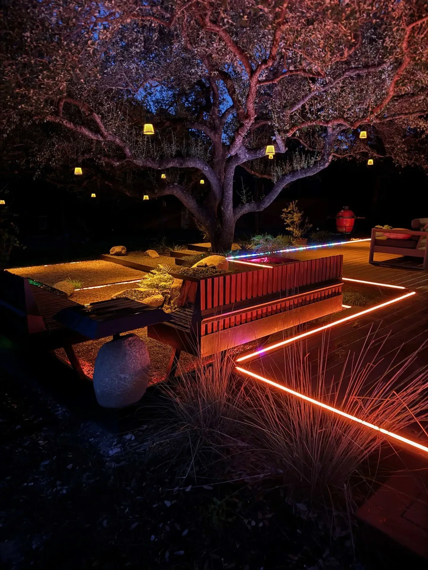 Nighttime WLED lighting on deck pathways and tree uplighting Austin TX