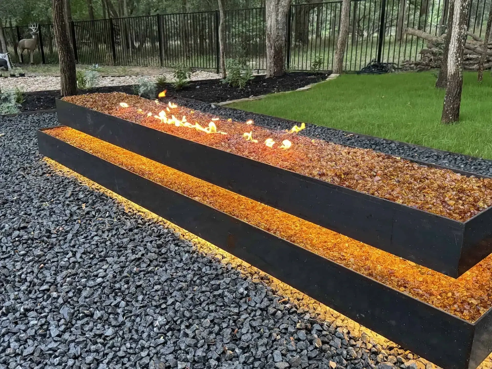 Lakeway Hardscape — 1,800 sq ft marbled concrete patio at $22/sq ft, 240 lf 1/4-inch steel edging, floating boulder fire pit, 24V FCOB perimeter lighting — Lakeway Austin TX