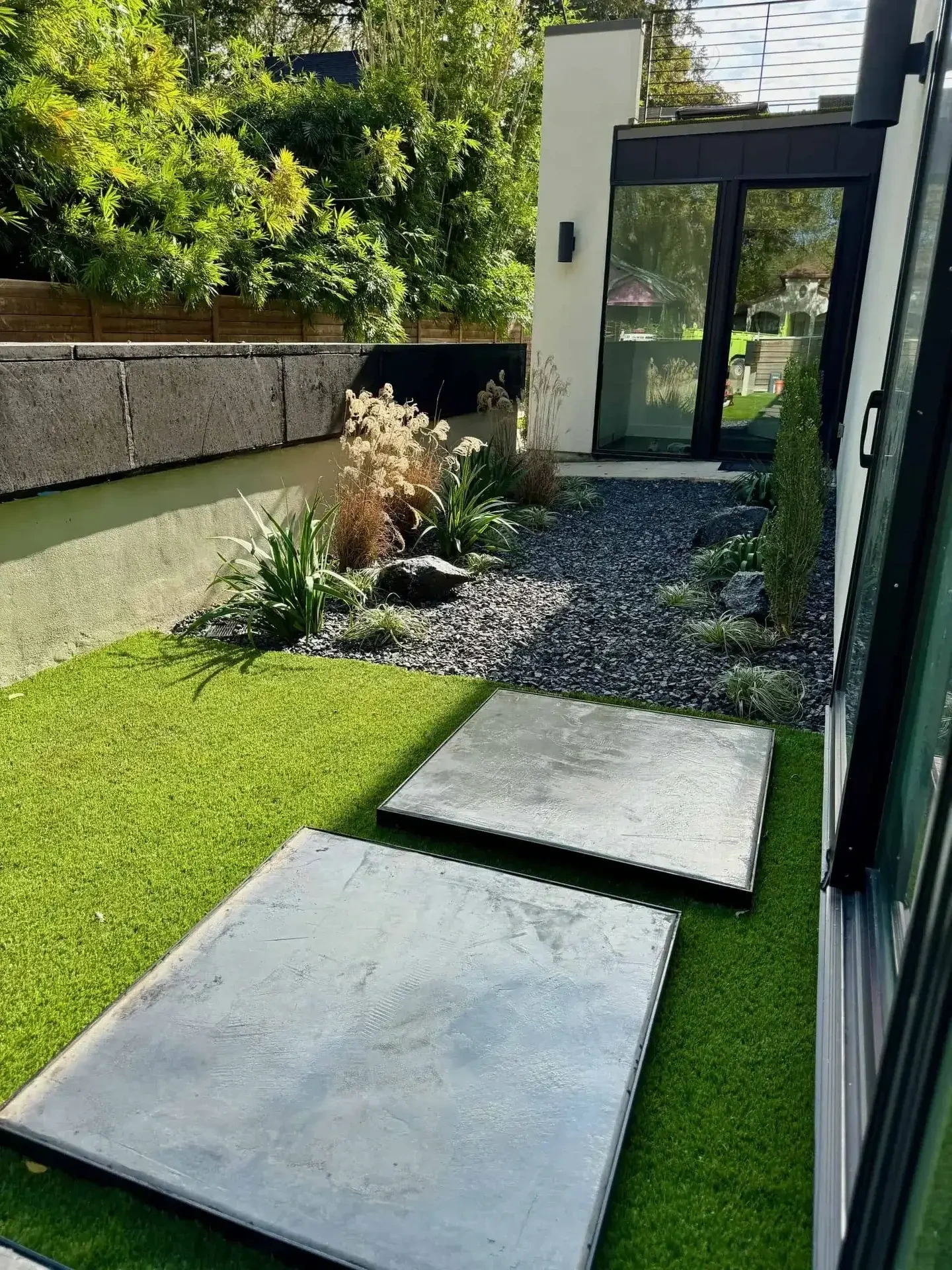 Concrete stepping pads with turf and retaining wall Austin TX