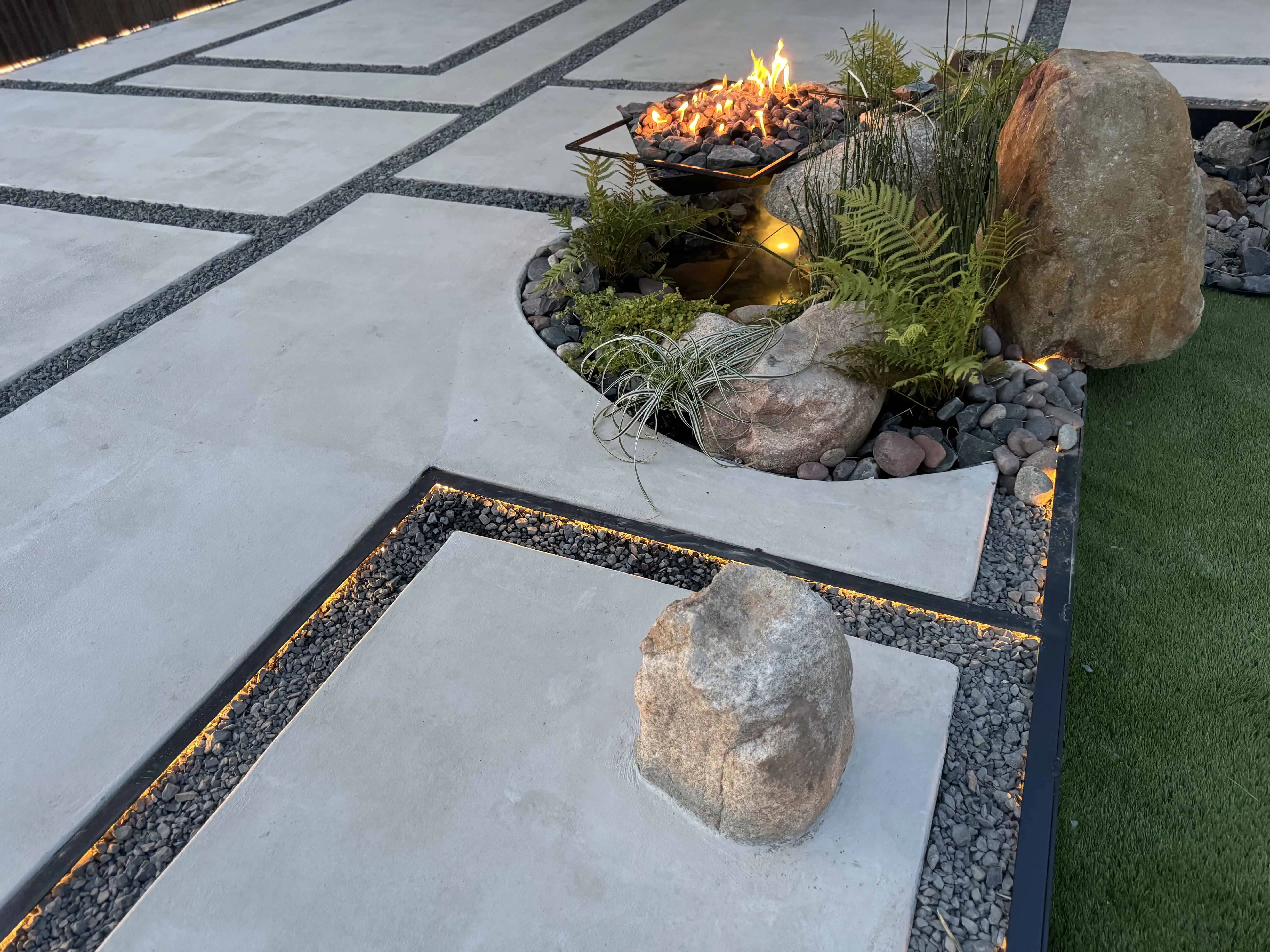Custom SureCrete Shure Broom pavers with COB-lit steel-edged joints — Pflugerville TX