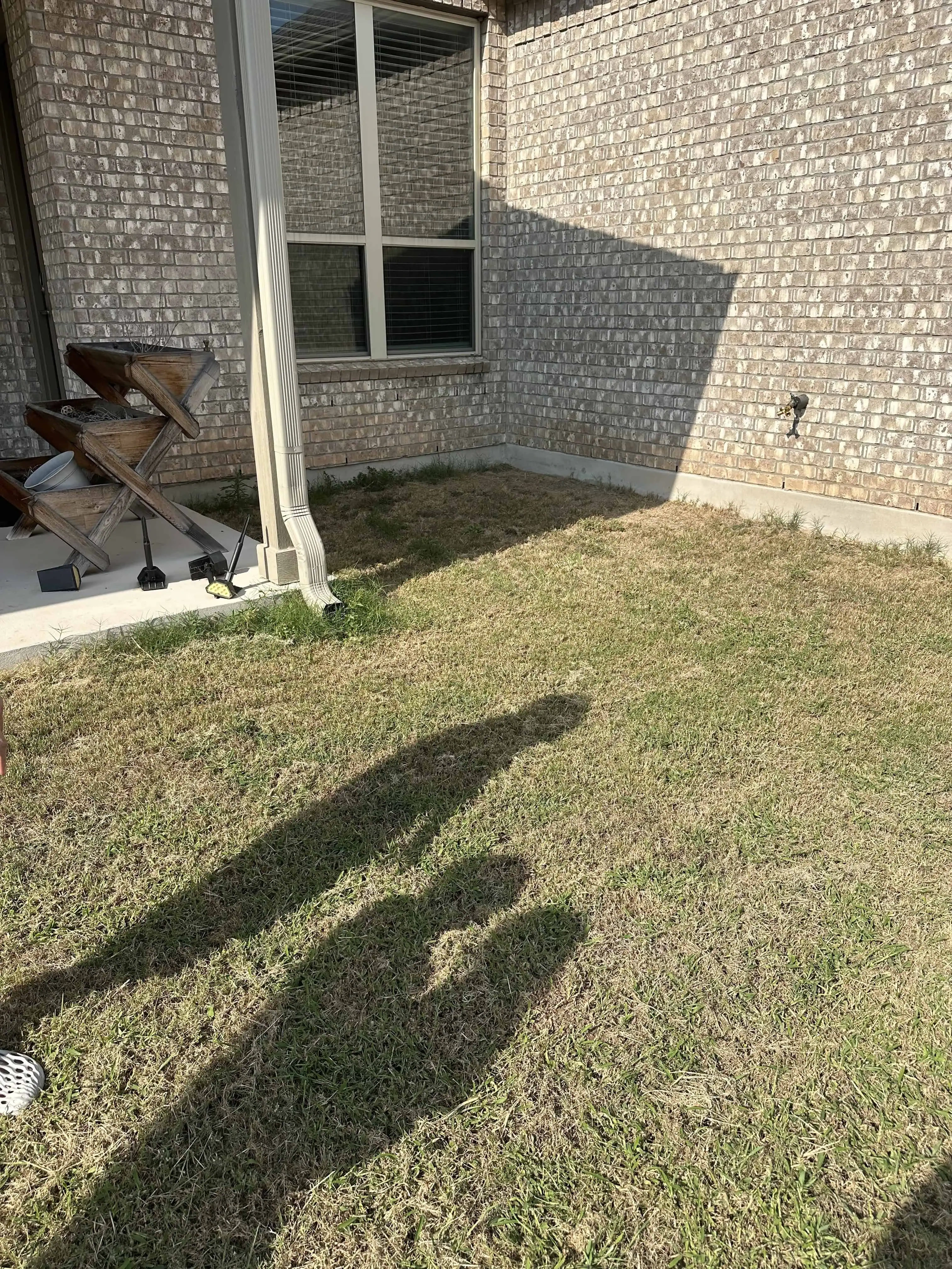 Axehandle project before — bare concrete patio