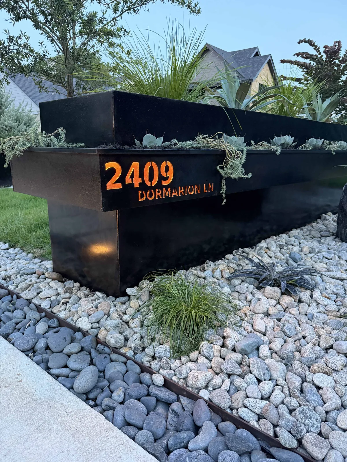 CNC-cut address sign 2409 Dormarion Ln with copper backing and COB lighting on cantilevered steel planter — Tarrytown Austin TX