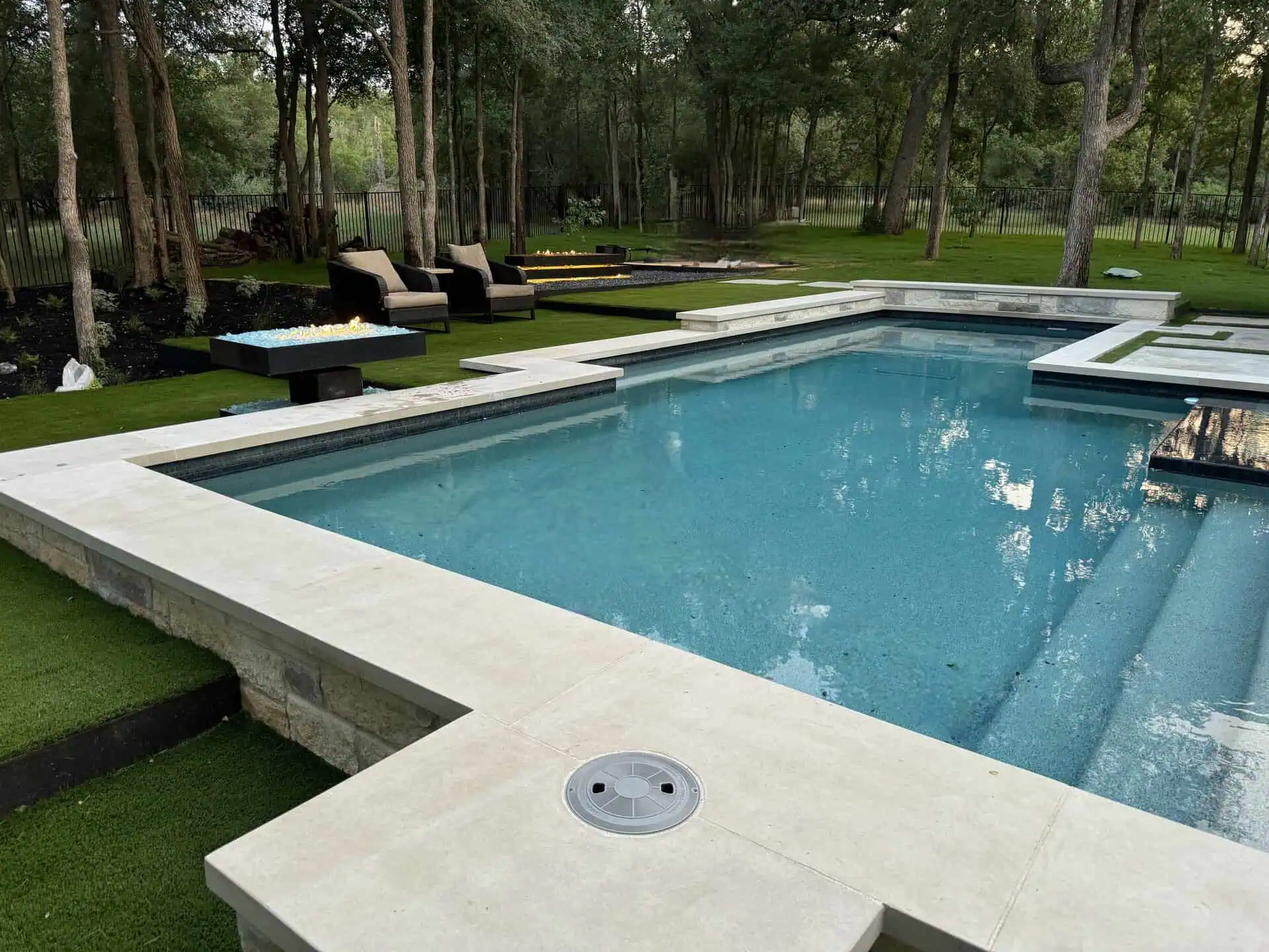 Custom pool with synthetic turf and fire pit Austin TX