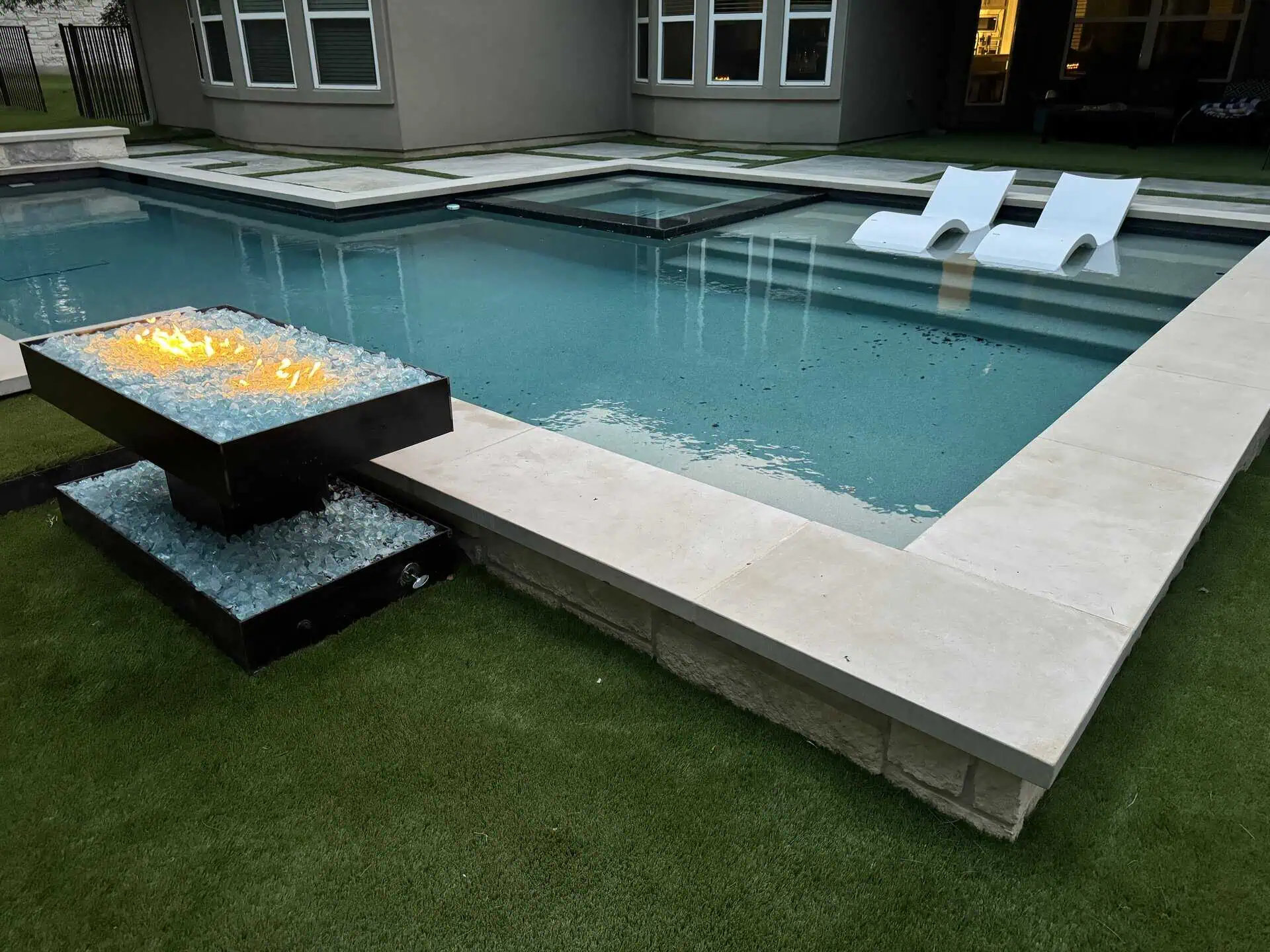 Pool-side welded steel fire pit with aqua fire glass — Austin TX