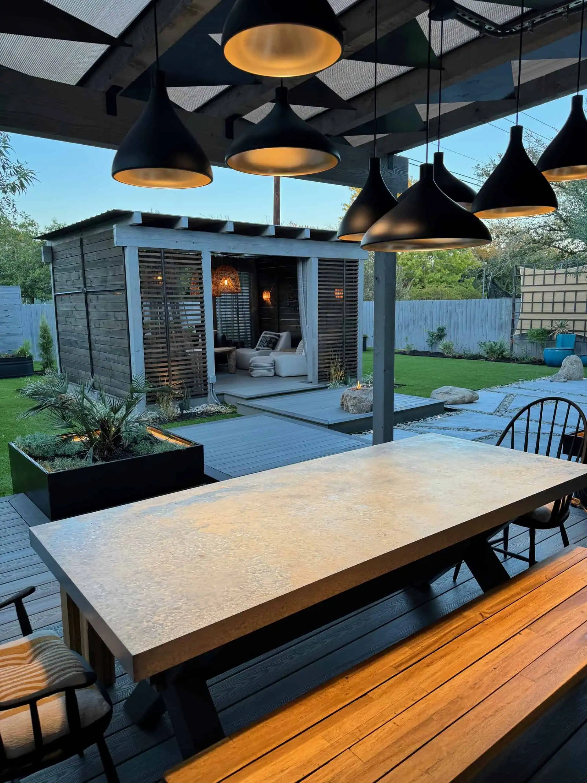 Custom-cut steel triangle pergola casting geometric shadows — Circle C, Austin TX