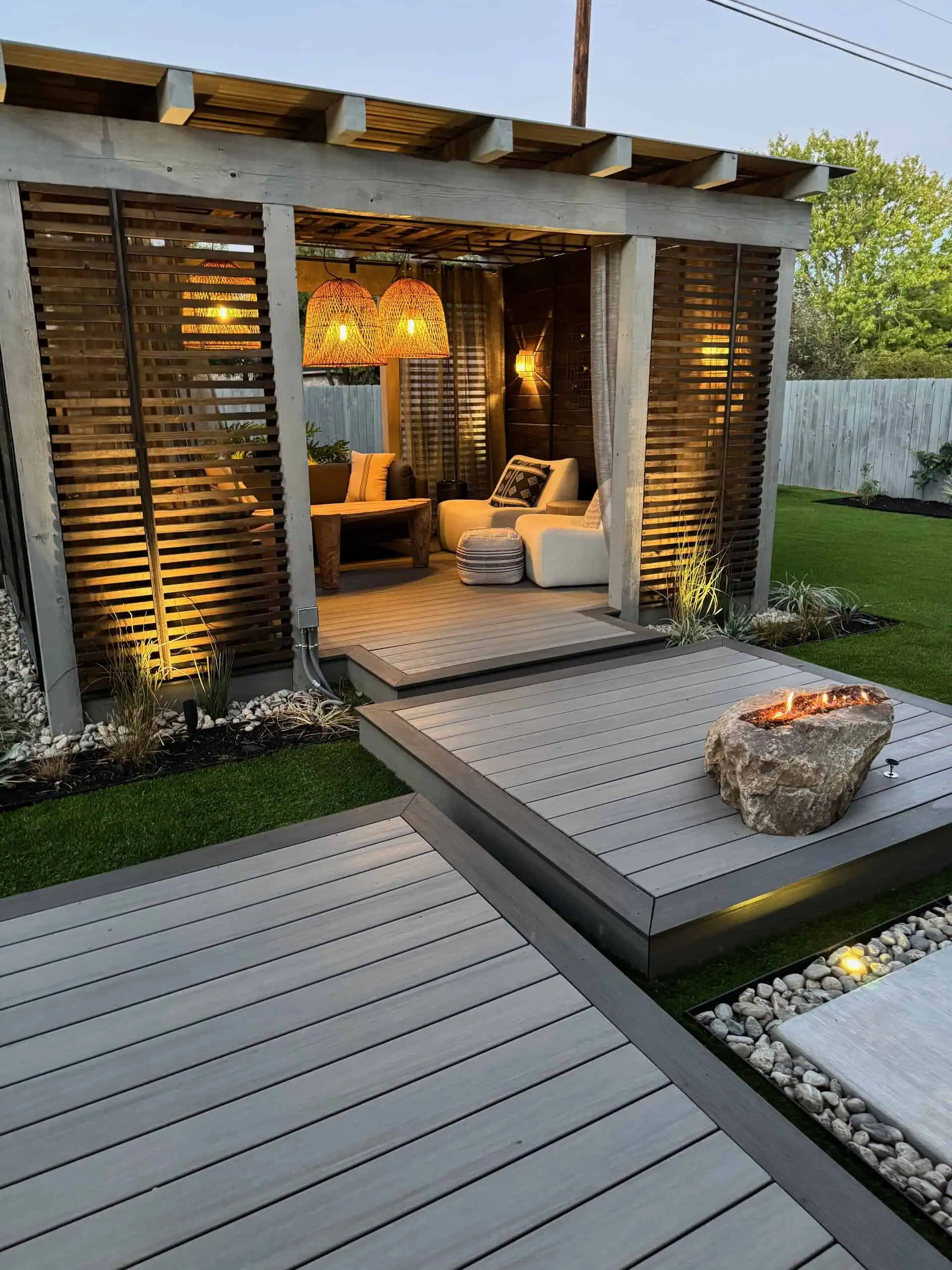 Boulder fire pit step hand-set into Sea Salt composite — Circle C, Austin TX