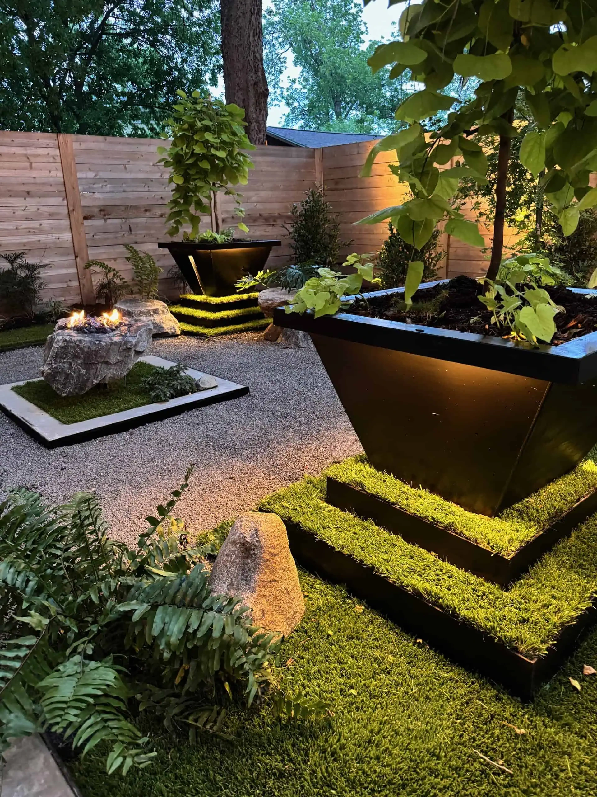 Madison project after — synthetic turf, boulder fire pit, landscape lighting