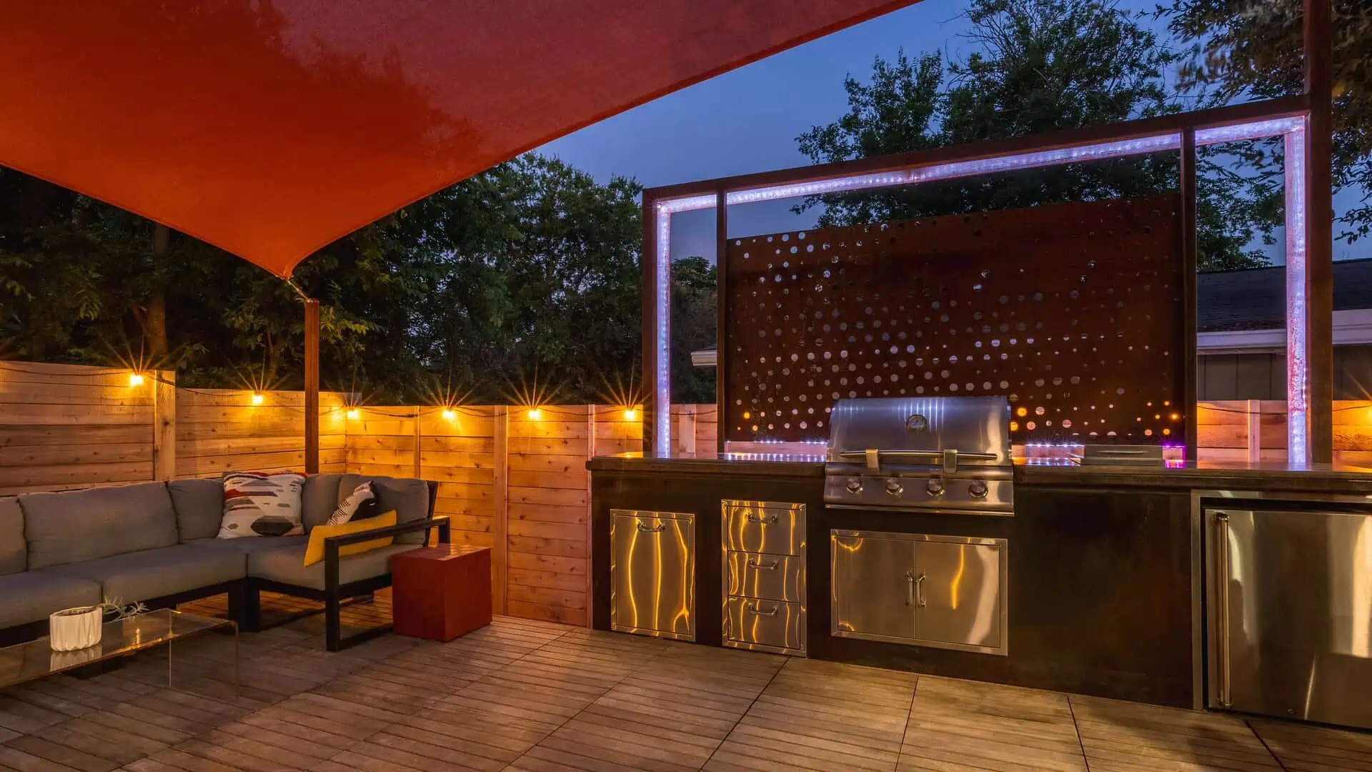 Outdoor kitchen with grill station and Corten backlit screen East Austin TX